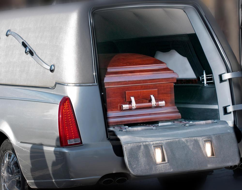A cemetery caretaker makes preparations for when a casket arrives.