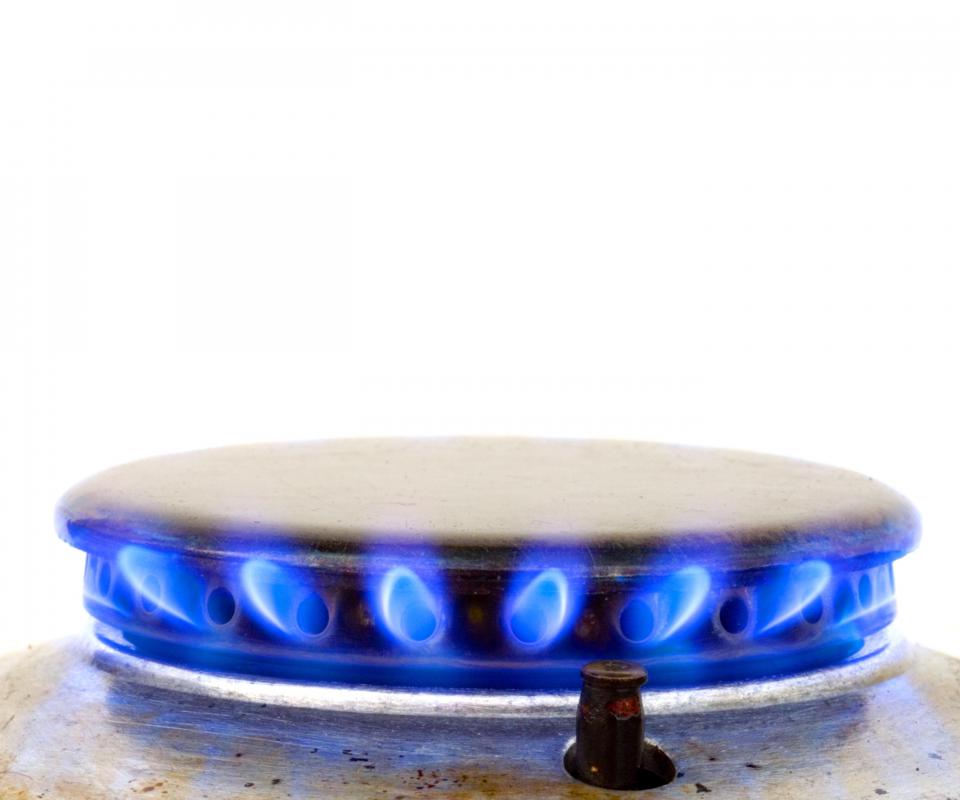 An appliance repairman may use a variety of tools to secure gas and water lines that will power the appliance.