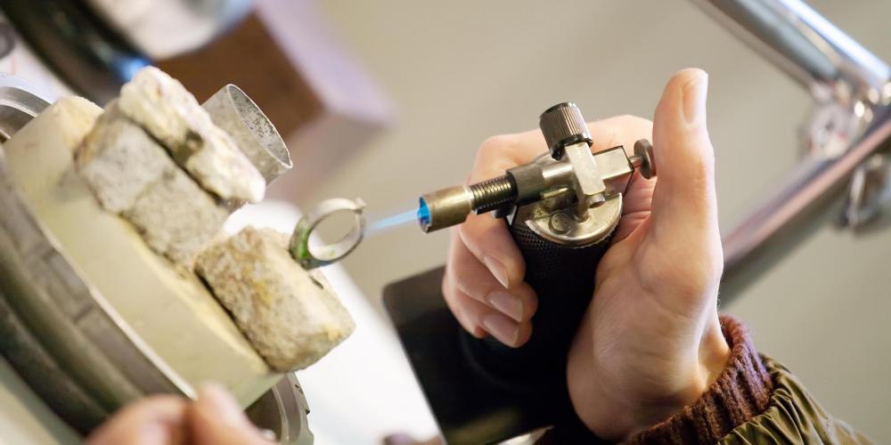 Jeweler use torches to resize rings.