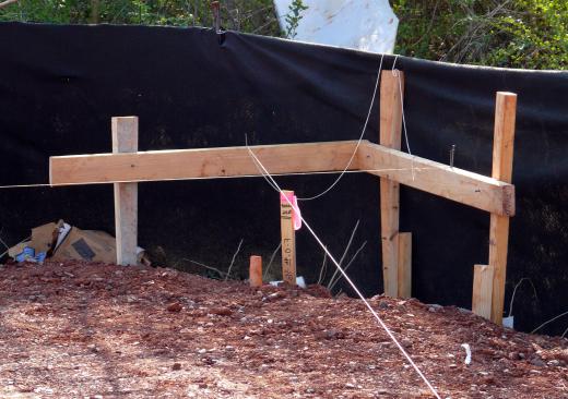 An excavating business may be hired to clear an area where a basement foundation will be built.