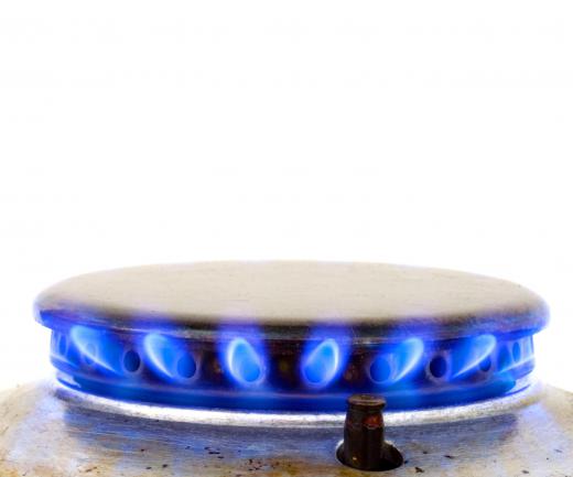 An appliance repairman may use a variety of tools to secure gas and water lines that will power the appliance.