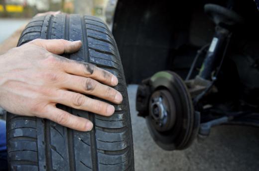 A mechanic may perform routine vehicle maintenance, like rotating the tires.