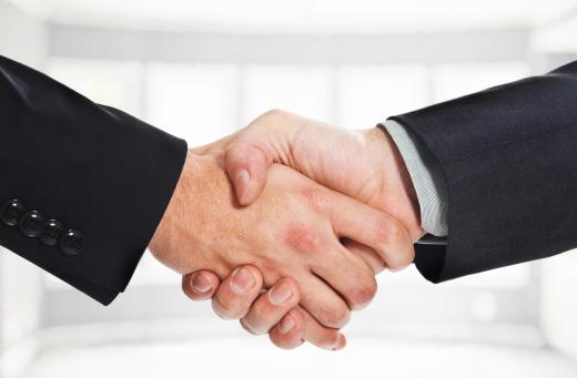 Proper business etiquette may include use of a handshake.