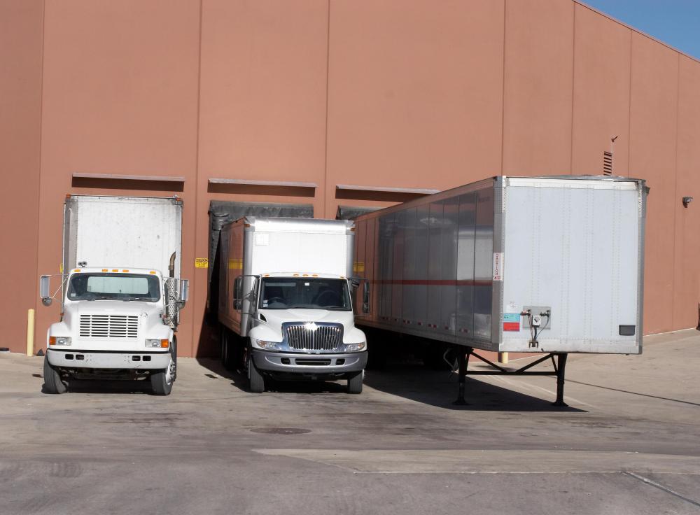 A logistics coordinator helps route and expedite movement of shipments in shipping docks.
