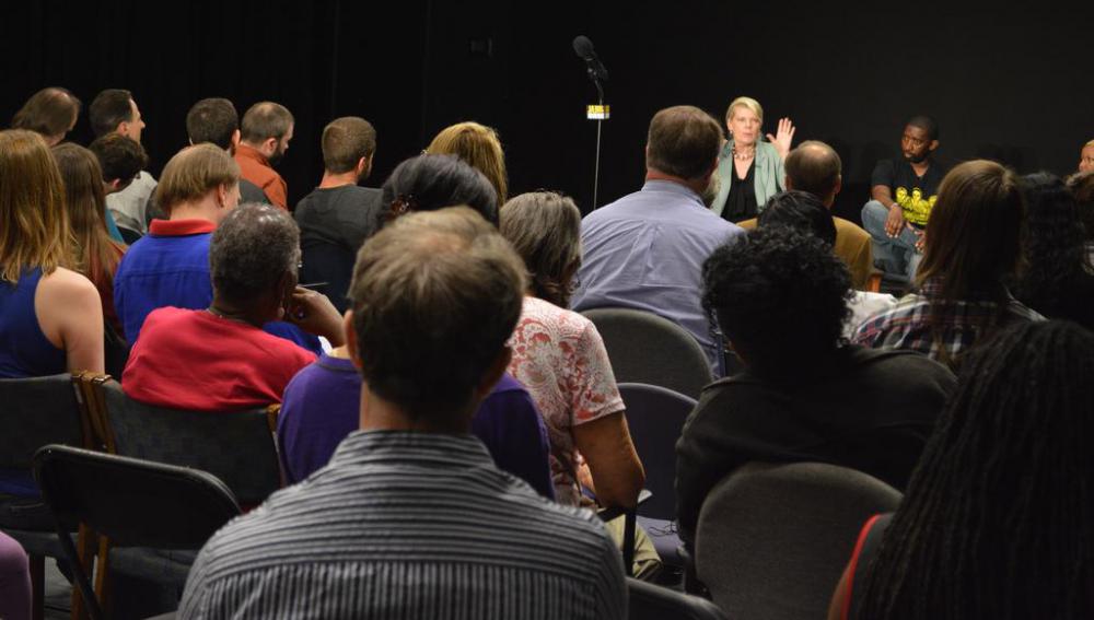 A professional fundraiser may organize a town hall meeting, at which individuals are asked to make donations towards the political campaigns of the candidates that they support.