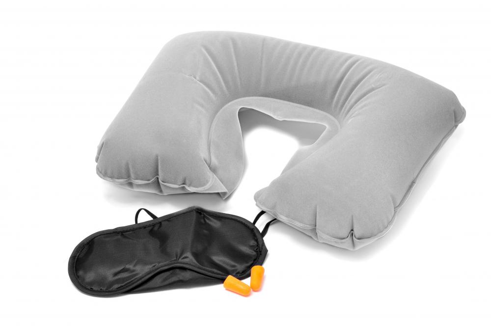 A corporate flight attendant may provide complimentary neck pillows and ear plugs to passengers.