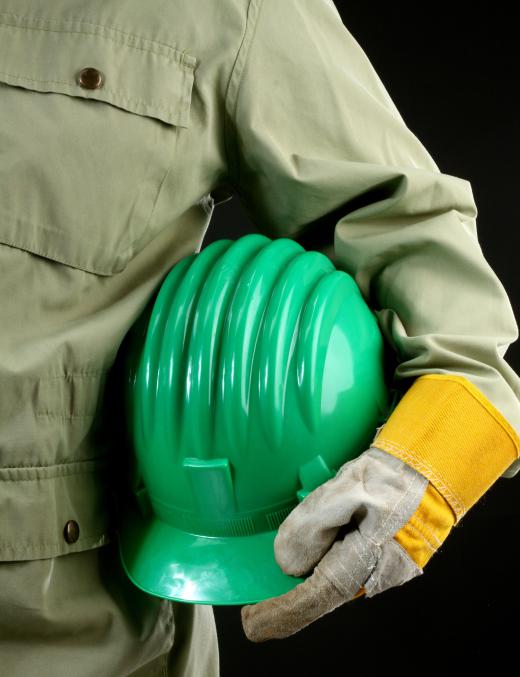 Machine builders must wear safety equipment such as hard hats.