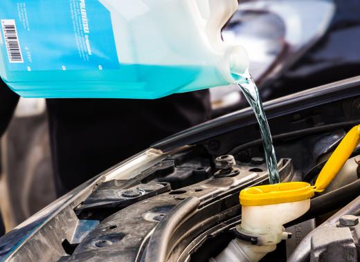 An auto service technician will often check and top off the necessary fluids in a vehicle, like antifreeze or transmission fluid.