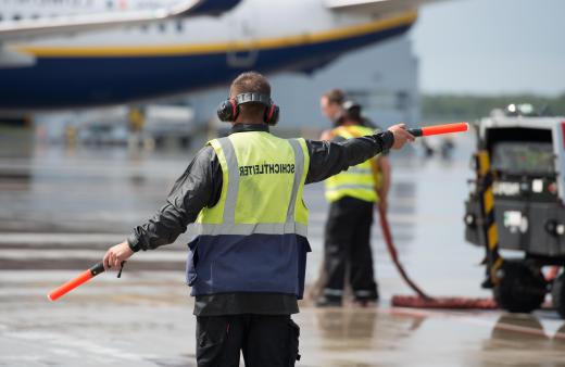 Baggage handlers may help position aircraft near the airport gates.