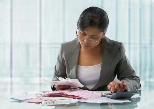 An auditor trainee going over business receipts.