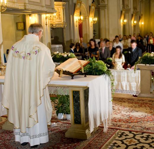 A wedding pastor conducts the marriage ceremony, including the reciting of the vows.