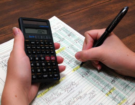 A bookkeeper reviews ledgers.