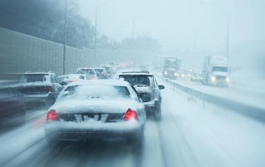 A trucking dispatcher is responsible for reporting and handling any delays that occur on route due to weather conditions.