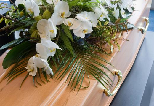 Mortuary technicians may help with the preparation of a casket.