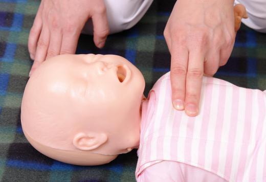 Infant CPR technique is taught on mannequins.