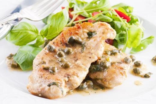 A photo of a plate of chicken piccata, likely prepared by a photo stylist who specializes in food.