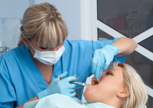 A dental hygienist administering local anesthesia.