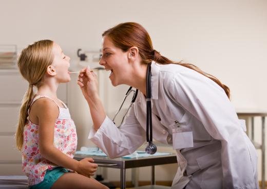 An otolaryngologist examining a child's throat.