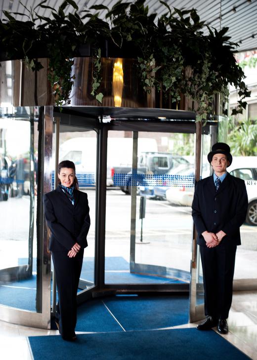 A hotel porter may serve as a doorman for guests.