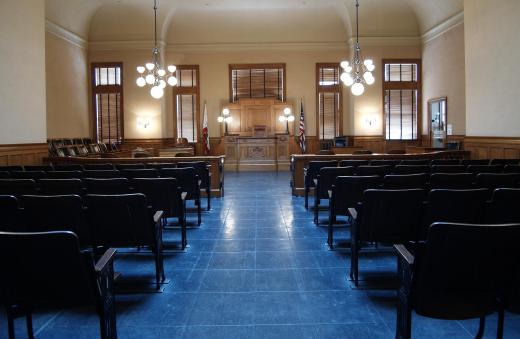 A bailiff checks the courtroom for dangerous items before each trial.