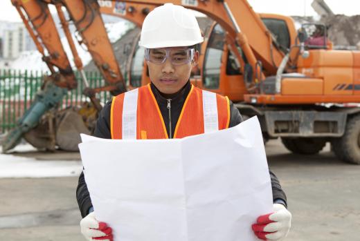 An onsite civil engineer reviews construction plans provided by the project manager.