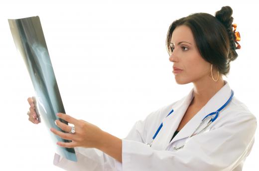 A diagnostic radiographer reviews X-rays.