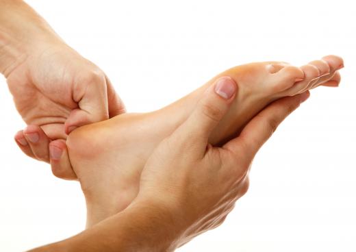 A cosmetologist performing a foot massage.