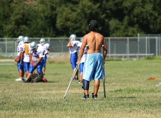 Physical therapists work with injured athletes.