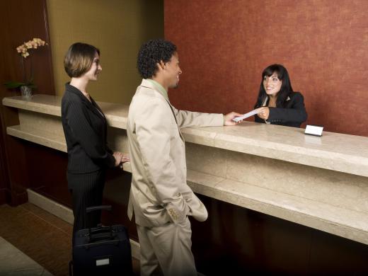 A hotel management trainee may check guests in.