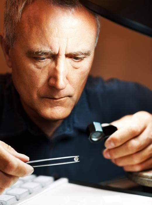 A jeweler inspecting a diamond.