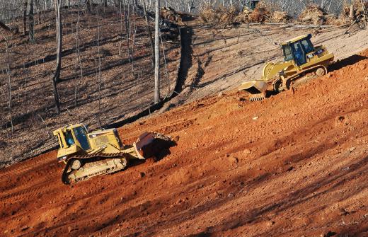 Bulldozers are capable of pushing dirt, rock, clay, sand, and vegetation.