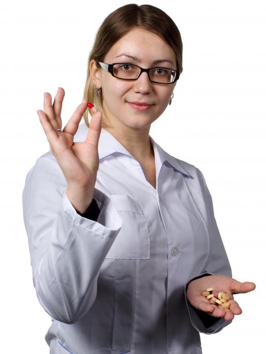 A medication aide dispenses prescriptions according to doctor orders.