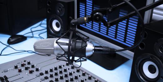 Promotions assistants at a radio station work in the booth next to the on-air talent.