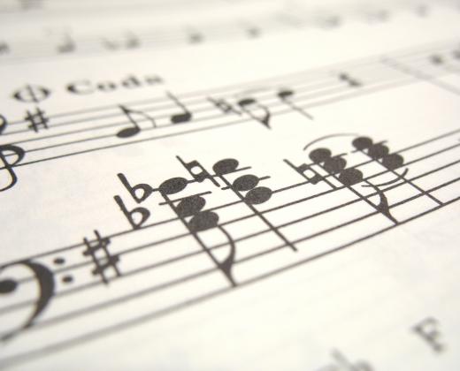 Music copyists create individual sheets of music for different instrument players.