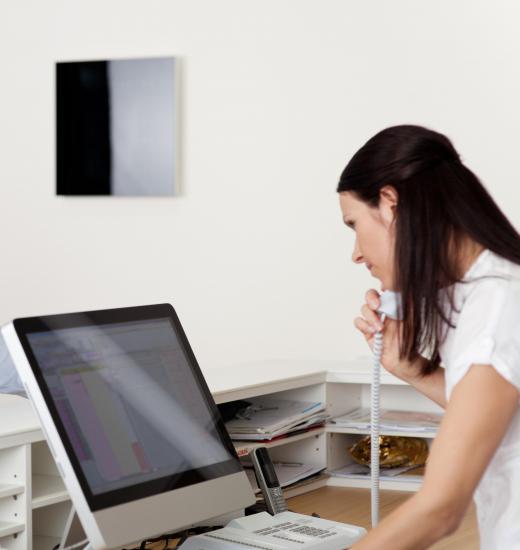 A medical secretary in an office does clerical work.