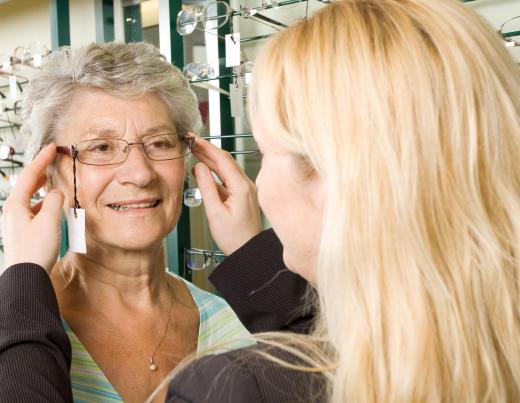 Eyeglass lenses are fitted to frames by opthalmic medical technicians.