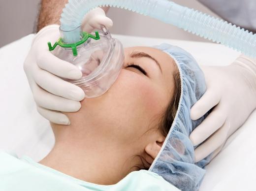 A nurse anesthetist, a type of nurse practitioner, administering anesthesia before surgery.