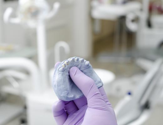 Dental technicians create a dental prostheses by using a dental impression of a patient's teeth.