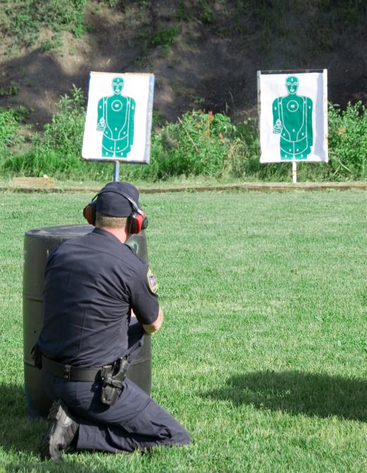 A man training at a shooting range.