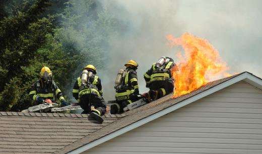 An adjuster may inspect damage done to a house during a fire to make assessments of the expenses involved in repair.