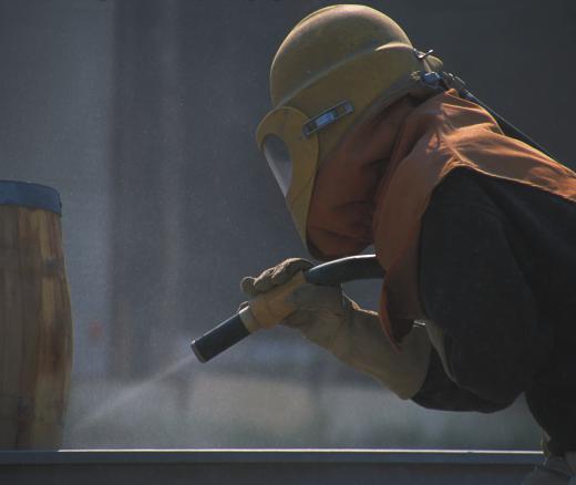 A person sandblasting.