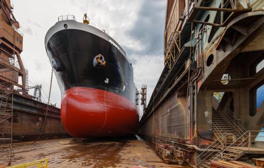 Drydock workers may be tasked with repairing a ship in drydock.