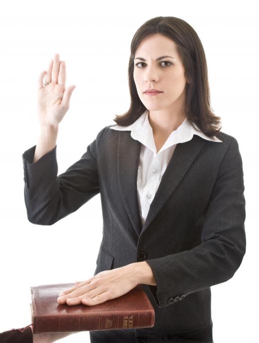 Court clerks administer the oath to swear in witnesses and jurors.