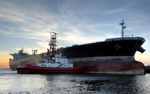 Tugboat crews are tasked with guiding larger vessels, like oil tankers, into harbors.