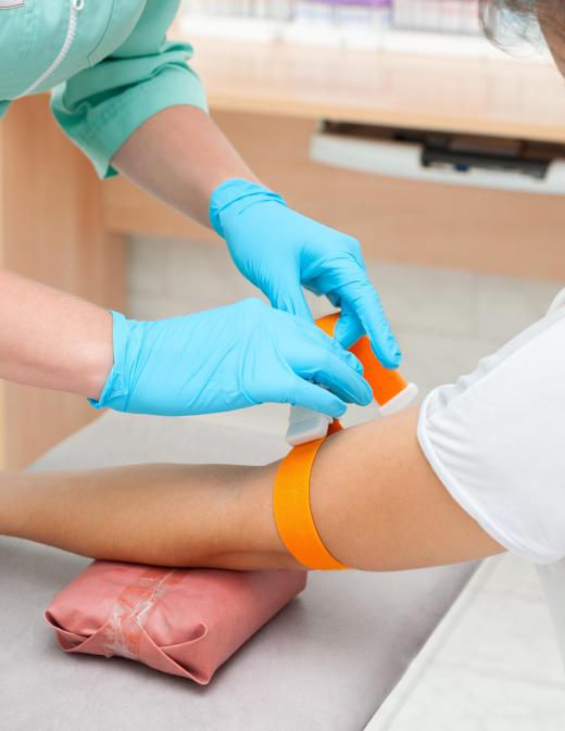 A tourniquet will be placed around a patient's arm by a medical professional before inserting an IV.