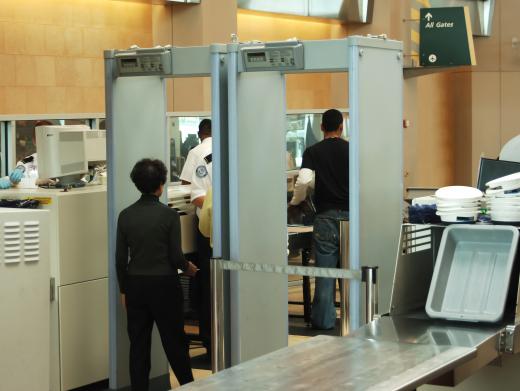 Airport security officers work at checkpoints at an airport.