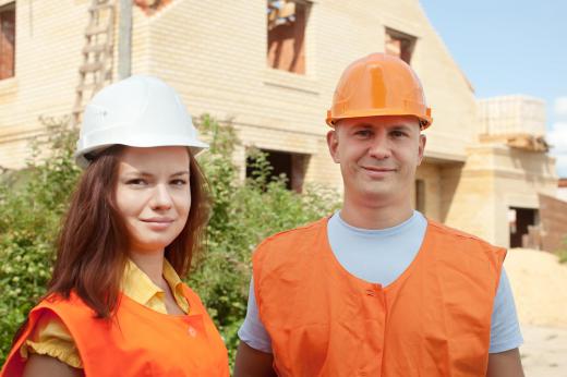 A construction trainee learns basic techniques under supervision.