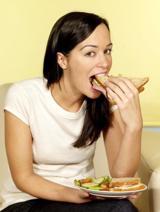 A woman eating a sandwich.