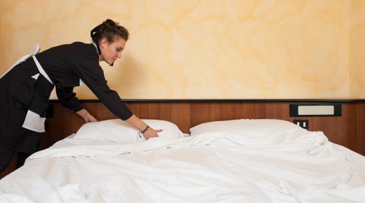 Laundry supervisors at a hotel ensure regular washing and changing of bed linens.