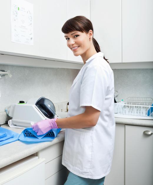 Laboratory aides are responsible for cleaning and sanitizing workspaces and equipment in a clinical lab setting.